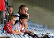 18 June 2011; Cork supporters, from left, six year old Mark Kelleher with his eight year old brother Robbie and father David from Mallow, Co. Cork, enjoy lunch before the start of the game. GAA Hurling All-Ireland Senior Championship Preliminary Round, Laois v Cork, O'Moore Park, Portlaoise, Co. Laois. Picture credit: Matt Browne / SPORTSFILE