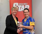 18 June 2011; President of the Camogie Association Joan Flynn presents Tipperary captain Jill Horan with the player of the match award after the game. All-Ireland Senior Camogie Championship, Round 2, in association with RTE Sport, Tipperary v Offaly, Semple Stadium, Thurles, Co. Tipperary. Picture credit: Barry Cregg / SPORTSFILE