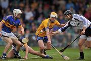 19 June 2011; Tipperary goalkeeper Brendan Cummins, right, and team-mate Michael Cahill contest possession with Conor McGrath, Clare. Munster GAA Hurling Senior Championship Semi-Final, Clare v Tipperary, Gaelic Grounds, Limerick. Picture credit: David Maher / SPORTSFILE