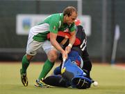 20 June 2011; Timothy Cockram, Ireland, is tackled by the Chinese goalkeeper Yin Yongbo. UCD Men's 4 Nations Tournament, Ireland v China, UCD, Belfield, Dublin. Picture credit: Brendan Moran / SPORTSFILE