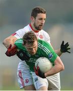 22 January 2017; Aidan Breen of Fermanagh in action against Niall Sludden of Tyrone during the Bank of Ireland Dr. McKenna Cup semi-final match between Tyrone and Fermanagh at St Tiernach's Park in Clones, Co. Monaghan. Photo by Oliver McVeigh/Sportsfile