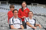 21 June 2011; Ulster Bank GAA stars Michael Fennelly, left, and John Gardnier pictured with pupils Sam Dinu and Lauren Kelly, from St. Joseph's Primary School, Newcastle, Co. Down, in Croke Park as part of the Ulster Bank/Irish News competition where five lucky classes won a school trip of a lifetime which included a tour of the famous Croke Park Stadium while also meeting some of the biggest GAA stars in the country. Croke Park, Dublin. Picture credit: Barry Cregg / SPORTSFILE
