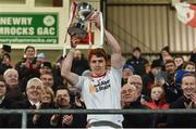 28 January 2017; Peter Harte of Tyrone holds aloft the Dr McKenna cup with Secretary of State for Northern Ireland  James Brokenshire MP standing in the background after the Bank of Ireland Dr. McKenna Cup Final match between Tyrone and Derry at Pairc Esler in Newry, Co. Down. Photo by Oliver McVeigh/Sportsfile