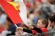 25 June 2011; A young Cork supporter waves his flag during the game. GAA Hurling All-Ireland Senior Championship Phase 1, Cork v Offaly, Pairc Ui Chaoimh, Cork. Picture credit: Brendan Moran / SPORTSFILE