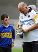 25 June 2011; Tipperary manager John Evans signs an autograph after the game. GAA Football All-Ireland Senior Championship Qualifier Round 1, Laois v Tipperary, O'Moore Park, Portlaoise, Co. Laois. Picture credit: Brendan Moran / SPORTSFILE