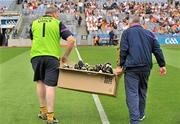 26 June 2011; Walter Byrne, left, Wexford kit man with Ger Fox, backroom staff, carry a box of football boots off the pitch  after some Wexford players had changed their boots before the start of the game against Carlow. Leinster GAA Football Senior Championship Semi-Final, Wexford v Carlow, Croke Park, Dublin. Picture credit: David Maher / SPORTSFILE