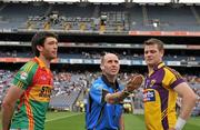 26 June 2011; Referee Michael Collins catches the coin with Wexford captain David Murphy, right, and Carlow captain Shane Redmond. Leinster GAA Football Senior Championship Semi-Final, Wexford v Carlow, Croke Park, Dublin. Picture credit: David Maher / SPORTSFILE