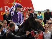 26 June 2011; Jockey Colm O'Donoghue celebrates onboard his mount Treasure Beach after victory in the Dubai Duty Free Irish Derby (Group 1). Horse Racing, The Curragh Racecourse, Co. Kildare. Picture credit: Pat Murphy / SPORTSFILE