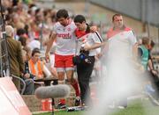 26 June 2011; Joe McMahon, Tyrone, leaves the field, helped by team physio Michael Harte, with a suspected concussion. Ulster GAA Football Senior Championship Semi-Final, Tyrone v Donegal, St Tiernach's Park, Clones, Co. Monaghan. Picture credit: Oliver McVeigh / SPORTSFILE