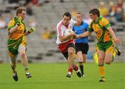 26 June 2011; Mark Donnelly, Tyrone, in action against Anthony Thompson and Paddy McGrath, right, Donegal. Ulster GAA Football Senior Championship Semi-Final, Tyrone v Donegal, St Tiernach's Park, Clones, Co. Monaghan. Picture credit: Oliver McVeigh / SPORTSFILE
