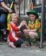 26 June 2011; Cousins Aoibhan Hegarty, left, from Urney, Co. Tyrone, and Conor Colton, from Castlefin, Co. Donegal, enjoy refreshments before the game. Ulster GAA Football Senior Championship Semi-Final, Tyrone v Donegal, St Tiernach's Park, Clones, Co. Monaghan. Picture credit: Michael Cullen / SPORTSFILE