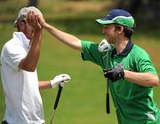 27 June 2011; Team Ireland's Gary Fleming, Monkstown, Co. Cork, celebrates with Danish golfer Morten Troels on the 18th green during the qualifying rounds at the Glyfada Golf Course. 2011 Special Olympics World Summer Games, Athens, Greece. Picture credit: Ray McManus / SPORTSFILE