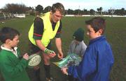 12 February 2002; A young Irish rugby fan gets his poster signed by Eric Miller after an Ireland Rugby Squad Training Session at Dr. Hickey Park in Greystones, Wicklow. Photo by Matt Browne/Sportsfile