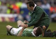 16 February 2002; Brian O'Driscoll of Ireland has spray applied to his leg by team physio Ailbe McCormack during the Lloyds TSB Six Nations Championship match between England and Ireland at Twickenham Stadium in London, England. Photo by Brendan Moran/Sportsfile