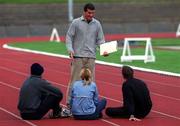 25 February 2002; Athletics coach Paul Doyle speaking with the three Irish athletes that he coaches in his training camp in Atlanta, Georgioa, USA, from left, Ciaran McDonagh, Karen Shinkins and Peter Coghlan, during a training session at Morton Stadium in Dublin. Photo by Brian Lawless/Sportsfile