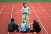 25 February 2002; Athletics coach Paul Doyle speaking to the Irish athletes who train in his training camp in Atlanta, Georgia, USA, from left, Ciaran McDonagh, Karen Shinkins and Peter Coghlan, during a training session at Morton Stadium in Dublin. Photo by Brendan Moran/Sportsfile