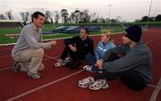 25 February 2002; Athletics coach Paul Doyle, left,  speaking to the Irish athletes who train with him at his training camp in Atlanta, Georgia, USA, from right, Ciaran McDonagh, Karen Shinkins and Peter Coghlan, during a training session at Morton Stadium in Dublin. Photo by Brendan Moran/Sportsfile
