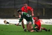 25 February 2002; Mark Keane of Limerick, in action against Diarmuid O'Sullivan, grounded, and Mark Prendergast of Cork during the Allianz National Hurling League Division 1B Round 1 match between Limerick and Cork at the Gaelic Grounds in Limerick. Photo by Brendan Moran/Sportsfile