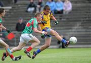 26 June 2011; Roscommon's Enda Smith scores his side's first goal despite the attempts of Mayo's Conor Horan. Connacht GAA Football Minor Championship Semi-Final, Mayo v Roscommon, McHale Park, Castlebar, Co. Mayo. Picture credit: Matt Browne / SPORTSFILE