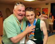 28 June 2011; Team Ireland's John Michael Gannon, Cloghan, Co. Offaly, with his dad Christy after winning a Gold Medal in the Male Horizontal Bar and a Silver for his performance on the Parallel Bars at the Hellinikon Olympic Indoor Hall, Hellinikon Olympic Complex. 2011 Special Olympics World Summer Games, Athens, Greece. Picture credit: Ray McManus / SPORTSFILE