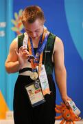 28 June 2011; Team Ireland's Alan Quinlan, Cappamore, Limerick, inspect his Silver Medal after the presentation for the Male Rings event at the Hellinikon Olympic Indoor Hall, Hellinikon Olympic Complex. 2011 Special Olympics World Summer Games, Athens, Greece. Picture credit: Ray McManus / SPORTSFILE