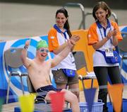 30 June 2011; Diarmuid O'Flynn, Kilkenny, Co. Kilkenny, is applauded by pool side volunteers before the 50 meter backstroke final at the OAKA Olympic Aquatic Center, Athens Olympic Sport Complex, Athens, Greece. 2011 Special Olympics World Summer Games, Athens, Greece. Picture credit: Ray McManus / SPORTSFILE