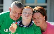30 June 2011; The youngest Team Ireland athlete, twelve year old Fergal Gregory, from Crossmaglen, Co. Armagh, celebrates, with his mother Aine and dad Kevin after winning a Gold medal in a 25M Butterfly Final in the OAKA Olympic Aquatic Center, Athens Olympic Sport Complex, Athens, Greece. 2011 Special Olympics World Summer Games, Athens, Greece. Picture credit: Ray McManus / SPORTSFILE