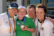 30 June 2011; The youngest Team Ireland athlete, twelve year old Fergal Gregory, Crossmaglen, Co. Armagh, celebrates with Aquatics Head Coach, Christine O’Halloran, left, Commons Road, Cork, Aquatics Coach, Frank Vahey, Ballinrobe, Co. Mayo, and Aquatics Coach, Jennifer Hughes, Baldoyle, Dublin 13, after he won a Gold medal in a 25M Butterfly Final in the OAKA Olympic Aquatic Center, Athens Olympic Sport Complex, Athens, Greece. 2011 Special Olympics World Summer Games, Athens, Greece. Picture credit: Ray McManus / SPORTSFILE