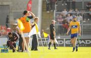 2 July 2011; James McInerney, Clare, leaves the pitch after being sent off by referee Diarmuid Kirwan. GAA Hurling All-Ireland Senior Championship, Phase 2, Galway v Clare, Pearse Stadium, Galway. Picture credit: Stephen McCarthy / SPORTSFILE