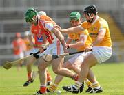 3 July 2011; Ruairi McGrattan, Armagh, in action against Joey Scullion, back, and Paddy Doherty, Antrim. Ulster GAA Hurling Senior Championship Final, Antrim v Armagh, Casement Park, Belfast, Co. Antrim. Picture credit: Pat Murphy / SPORTSFILE