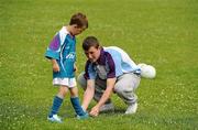 7 July 2011; Cameron Caffrey has his lace tied by group leader Jack King during a GAA VHI Cúl Camp in Clonliffe College, Dublin. The camps, sponsored and subsidised by Croke Park and the GAA, catered for more than 150 local children from the Croke Park locality under the direction of camp co-ordinator Liam Ryan this week. Clonliffe College, Clonliffe Road, Dublin. Picture credit: Brendan Moran / SPORTSFILE