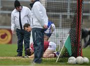 11 February 2017; Cormac O'Doherty of Slaughtneil on the ground after colliding with the post as Michael Savage of St Vincent's shows concern during the AIB GAA Football All-Ireland Senior Club Championship semi-final match between Slaughtneil and St Vincent's at Páirc Esler in Newry. Photo by Oliver McVeigh/Sportsfile
