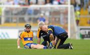 10 July 2011; Clare captain Tony Kelly receives treatment from physio Diarmuid Horgan during the game. Munster GAA Hurling Minor Championship Final, Clare v Waterford, Pairc Ui Chaoimh, Cork. Picture credit: Diarmuid Greene / SPORTSFILE