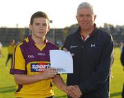13 July 2011; Ger Cunningham, Sports Sponsorship Manager, Bord Gais, presents Conor Tobin, Shelmaliers, Wexford, with a voucher for €500 after he won the now famous Bord Gáis Energy Crossbar Challenge at half-time in the Bord Gáis Energy Leinster Hurling U-21 Final between Dublin and Wexford, Wexford Park, Wexford. Picture credit: Pat Murphy / SPORTSFILE