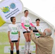 16 July 2011; Frank Greally, Editor, Irish Runner, presents the women's race winner Siobhan O'Doherty, from Borrisokane, Co. Tipperary, with her prize, in the company of 2nd placed Julie Turley and 3rd placed Gladys Ganiel O'Neill, left, after The National Lottery Irish Runner 5 Mile. Phoenix Park, Dublin. Picture credit: Brendan Moran / SPORTSFILE