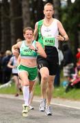 16 July 2011; Annmarie Hickey, left, Raheny Shamrocks A.C., and Simon Monds, Kilcoole A.C., in action during The National Lottery Irish Runner 5 Mile. Phoenix Park, Dublin. Picture credit: Tomas Greally / SPORTSFILE