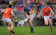 16 July 2011; Conor McGraynor, Wicklow, in action against Brendan Donaghy, 3, and Charlie Vernon, Armagh. GAA Football All-Ireland Senior Championship Qualifier, Round 2, Replay, Wicklow v Armagh, County Grounds, Aughrim, Co. Wicklow. Picture credit: Ray McManus / SPORTSFILE