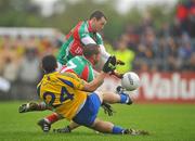 17 July 2011; Ger Heneghan, Roscommon, has his shot blocked by Mayo's Trevor Mortimer, 7, and Keith Higgins during the closing seconds of added time. Connacht GAA Football Senior Championship Final, Roscommon v Mayo, Dr. Hyde Park, Roscommon. Picture credit: David Maher / SPORTSFILE