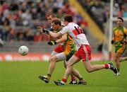 17 July 2011; Anthony Thompson, Donegal, in action against Michael Bateson and Barry McGoldrick, Derry. Ulster GAA Football Senior Championship Final, Derry v Donegal, St Tiernach's Park, Clones, Co. Monaghan. Picture credit: Oliver McVeigh / SPORTSFILE