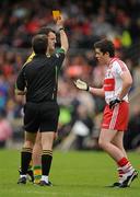17 July 2011; Michael Murphy, Donegal, and Dermot McBride, Derry, are shown a yellow card by referee Maurice Deegan. Ulster GAA Football Senior Championship Final, Derry v Donegal, St Tiernach's Park, Clones, Co. Monaghan. Picture credit: Brendan Moran / SPORTSFILE