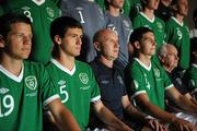 18 July 2011; Republic of Ireland head coach Paul Doolin sits with his players, from left to right, Conor Smith, Anthony O'Connor and captain John Egan during their squad portrait session. 2010/11 UEFA European Under-19 Championship, Intercontinental Hotel, Bucharest, Romania. Picture credit: Stephen McCarthy / SPORTSFILE