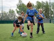 20 July 2011; Hugo Martin, aged 7, from Ranelagh, Dublin, rolls the ball back to Eoghan O'Riordan, aged 7, from Clonskeagh, Dublin, in a game of tag rugby during the Volkswagen Leinster Summer Camp, Lansdowne Rugby Club, Lansdowne Road, Dublin. Picture credit: Barry Cregg / SPORTSFILE