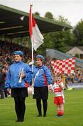 17 July 2011;  Derry mascot four year Donal O'Connor along with his mother Moira O'Connor, a flag bearer with St. Michael's Scout Brass Band Enniskillen, before the game. Ulster GAA Football Senior Championship Final, Derry v Donegal, St Tiernach's Park, Clones, Co. Monaghan. Picture credit: Oliver McVeigh / SPORTSFILE