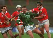 25 February 2002; Mark Foley of Limerick in action against Cork's Neil Ronan, left, and Pat Ryan during the Allianz National Hurling League Division 1B Round 1 match between Limerick and Cork at the Gaelic Grounds in Limerick. Photo by Brendan Moran/Sportsfile