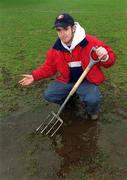 26 February 2002; St Patrick's Athletic head groundsman Gerard Foster tends to the Richmond Park pitch following the postponement of the eircom League Premier Division match between St Patrick's Athletic and Derry City at richmond Park in Dublin. Photo by Damien Eagers/Sportsfile