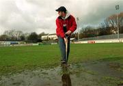 26 February 2002; St Patrick's Athletic head groundsman Gerard Foster tends to the Richmond Park pitch following the postponement of the eircom League Premier Division match between St Patrick's Athletic and Derry City at richmond Park in Dublin. Photo by Damien Eagers/Sportsfile