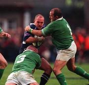 2 March 2002; Gregor Townsend of Scotland is tackled by John Hayes, left, and Peter Clohessy of  Ireland during the Lloyds TSB Six Nations Rugby Championship match between Ireland and Scotland at Lansdowne Road in Dublin. Photo by Brendan Moran/Sportsfile