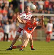 23 July 2011; Charlie Vernon, Armagh, in action against Kevin Hughes, Tyrone. GAA Football All-Ireland Senior Championship Qualifier Round 3. Tyrone v Armagh, Healy Park, Omagh, Co. Tyrone. Picture credit: Oliver McVeigh / SPORTSFILE
