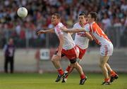 23 July 2011; Tommy McGuigan, Tyrone, in action against Finnian Moriarty, Armagh. GAA Football All-Ireland Senior Championship Qualifier Round 3. Tyrone v Armagh, Healy Park, Omagh, Co. Tyrone. Picture credit: Oliver McVeigh / SPORTSFILE