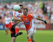 23 July 2011; Ryan McMenamin, Tyrone, in action against Steven McDonnell, Armagh. GAA Football All-Ireland Senior Championship Qualifier Round 3. Tyrone v Armagh, Healy Park, Omagh, Co. Tyrone. Picture credit: Michael Cullen / SPORTSFILE